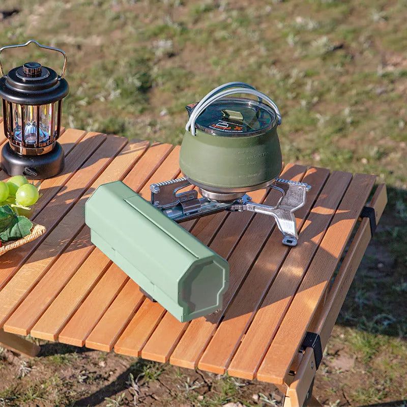 Green folding camping gas stove with adjustable valve and anti-slip feet for outdoor cooking