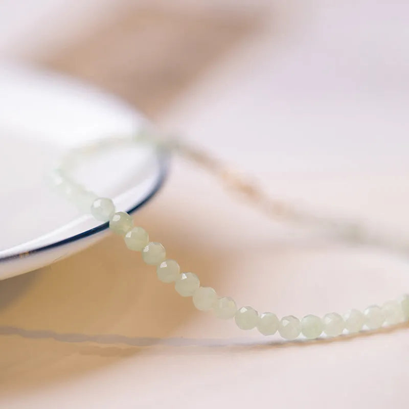 Women's Korean style retro jade bracelet in ball type design on a wrist.
