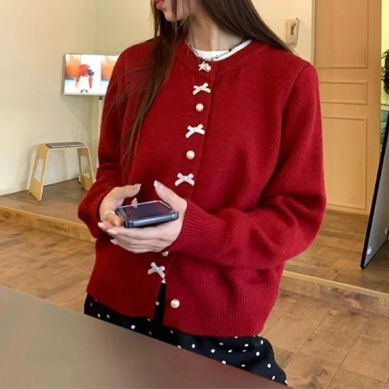 Women's solid colour cardigan sweater with bow and pearl button design in medium thickness fabric
