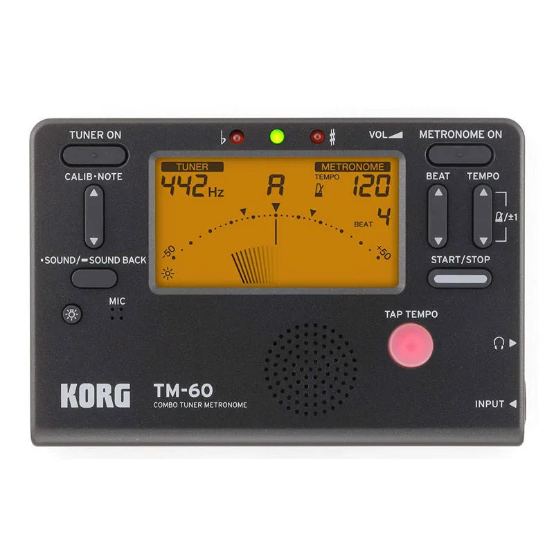 TM-60 black and white universal electronic metronome and tuner on a table.