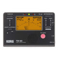 TM-60 black and white universal electronic metronome and tuner on a table.