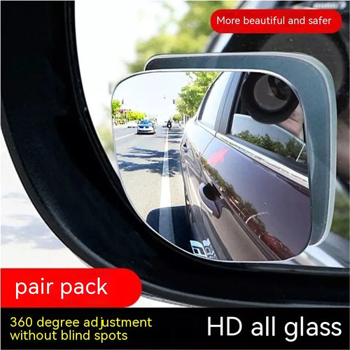 A pair of small, fan-shaped white glass blind spot mirrors for cars, showing 360-degree adjustable mounting.