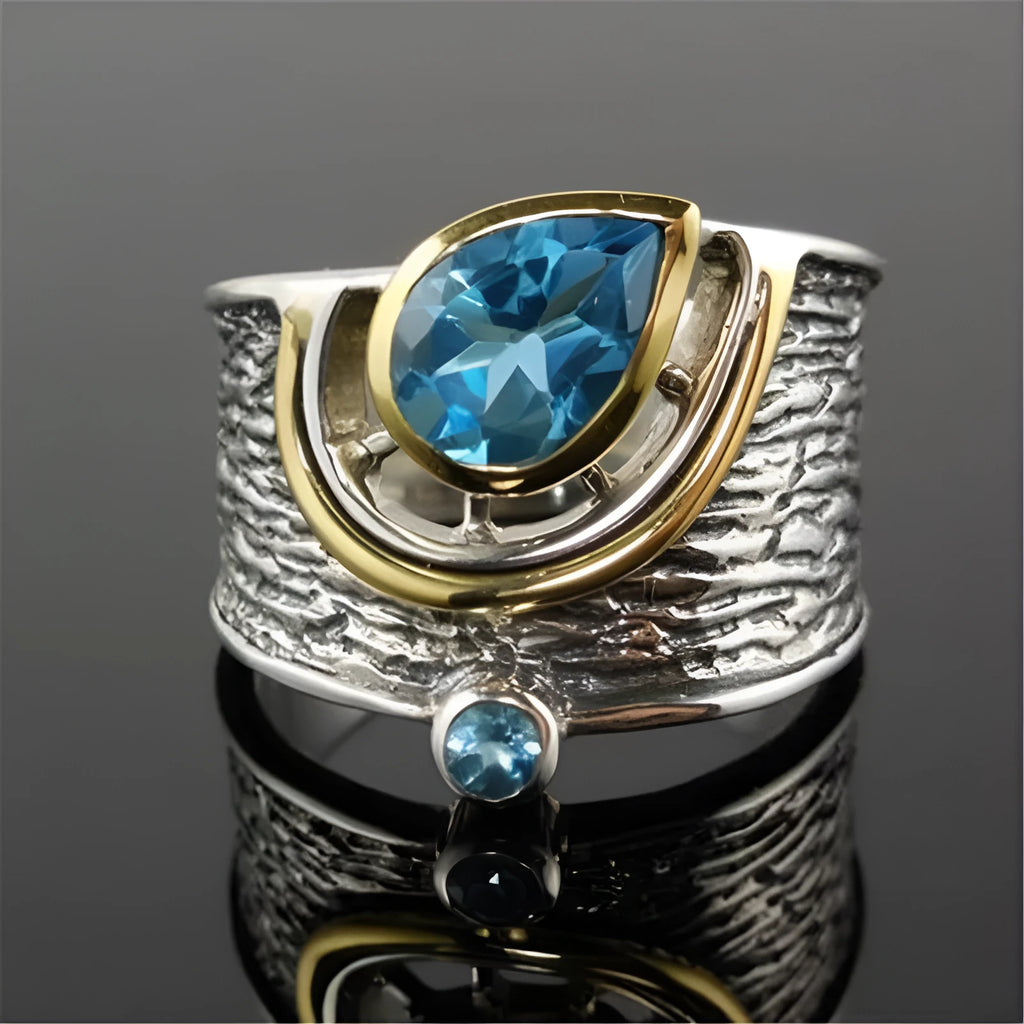 Blue zircon Chinese style women's ring with drop shape and rhinestone detailing on alloy band