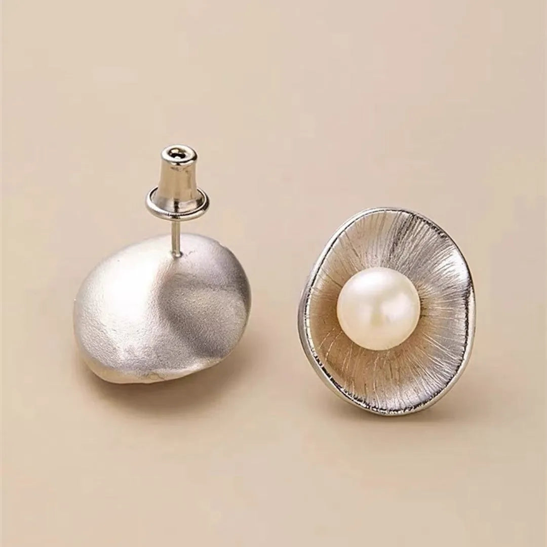 Pearl sterling silver needle earrings with geometric design and gold electroplated finish