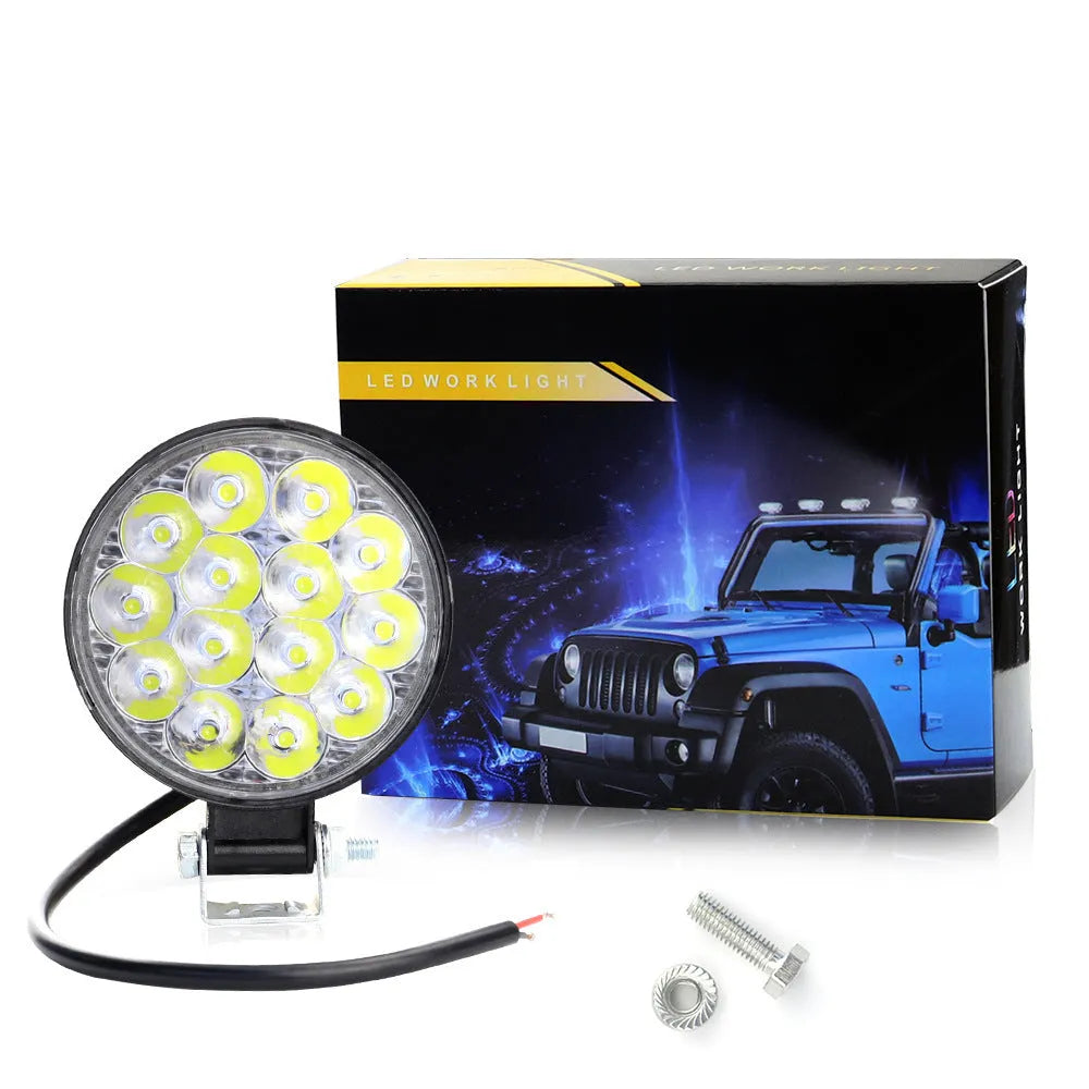 White LED mini round auxiliary work light with aluminium housing for vehicle mounting.