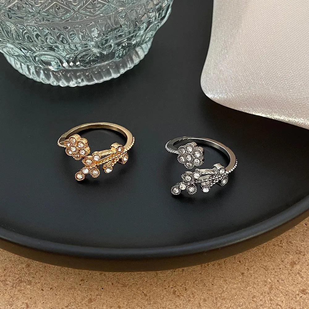 Open mouth copper ring with flower and leaf design in a gold finish