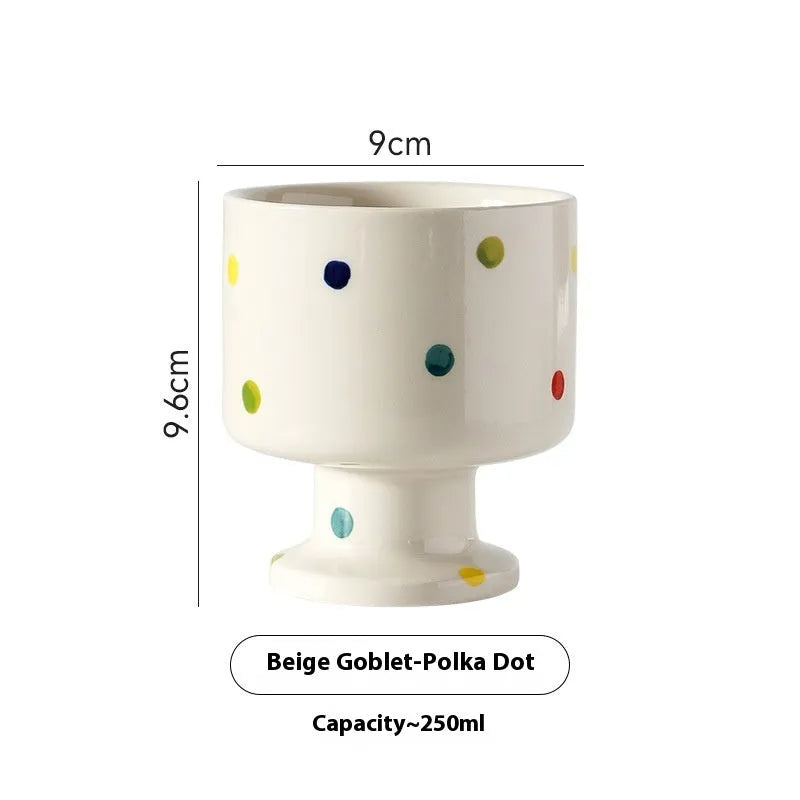 Hand-pinched irregular shaped ceramic mug in a solid colour on a table.