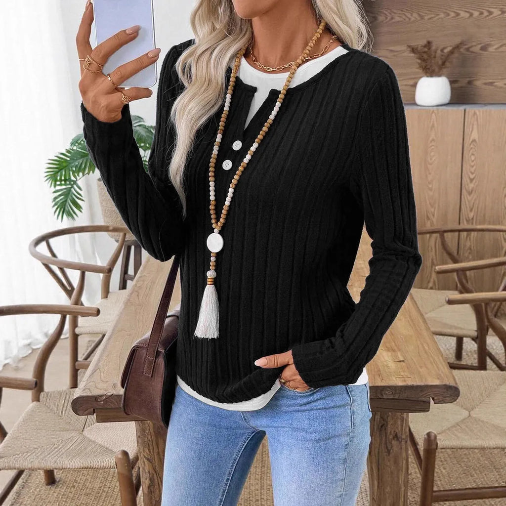 Women's black fake two-piece round neck pullover sweater with long sleeves.