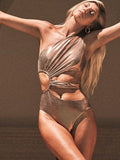Women's gold backless one-piece swimsuit with sleeveless design on mannequin