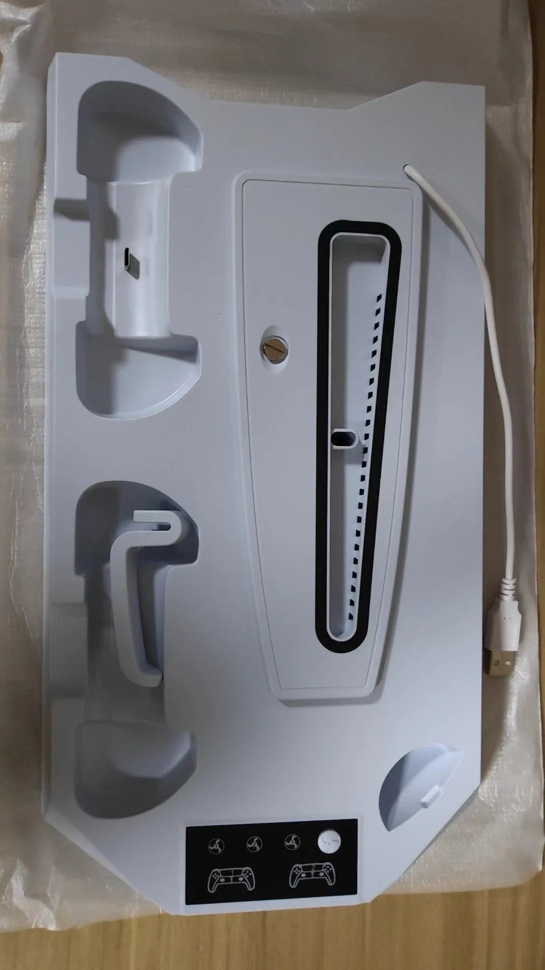 Black and white PS5 charging station with controller dock and headset hook