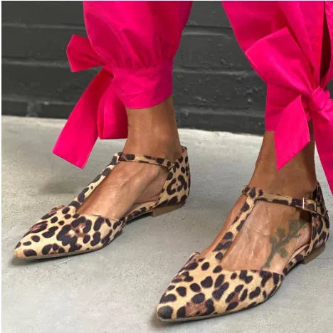 Leopard print women's pumps with pointed toe and low chunky heel featuring cross shoulder straps
