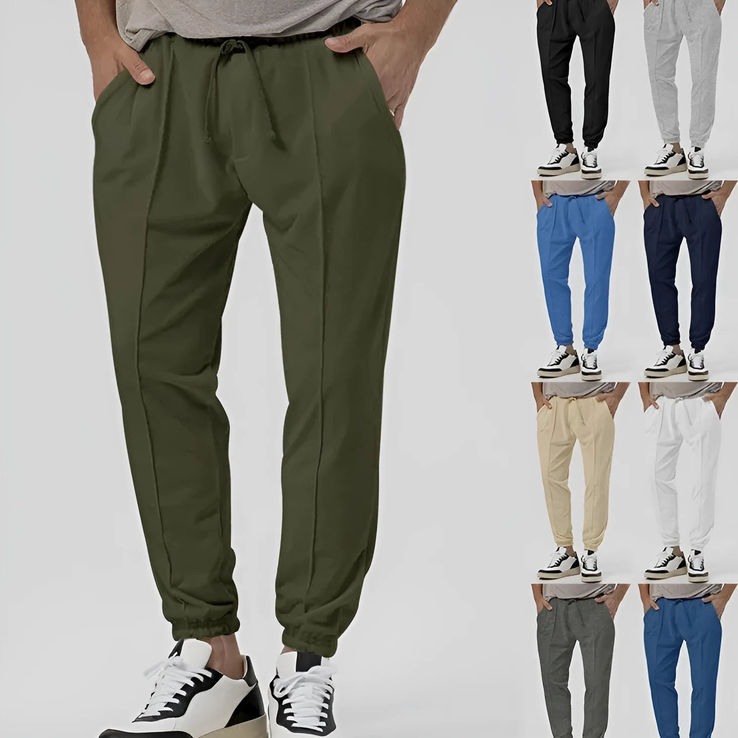 Men's grey loose tapered track sweatpants with elastic waist and straight leg design.