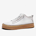 Men's black casual leather shoes with a round toe and white rubber sole on a plain background.