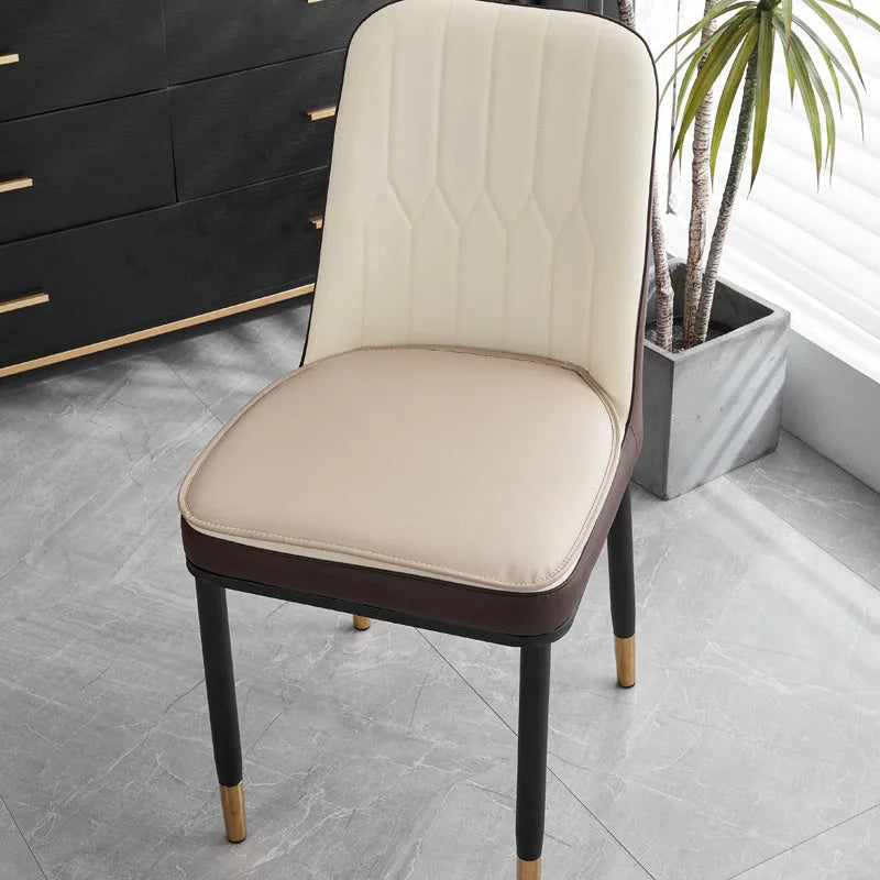 Beige leather horseshoe-shaped seat cushion with anti-slip base on a wooden chair