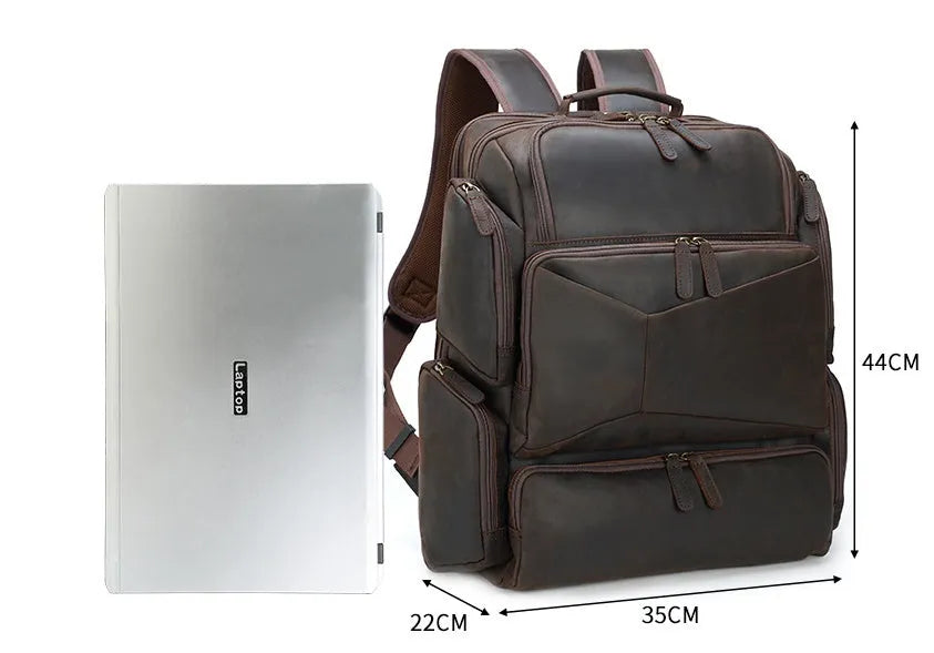 Dark brown retro crazy horse leather men's backpack open to show 17-inch laptop compartment and internal pockets.