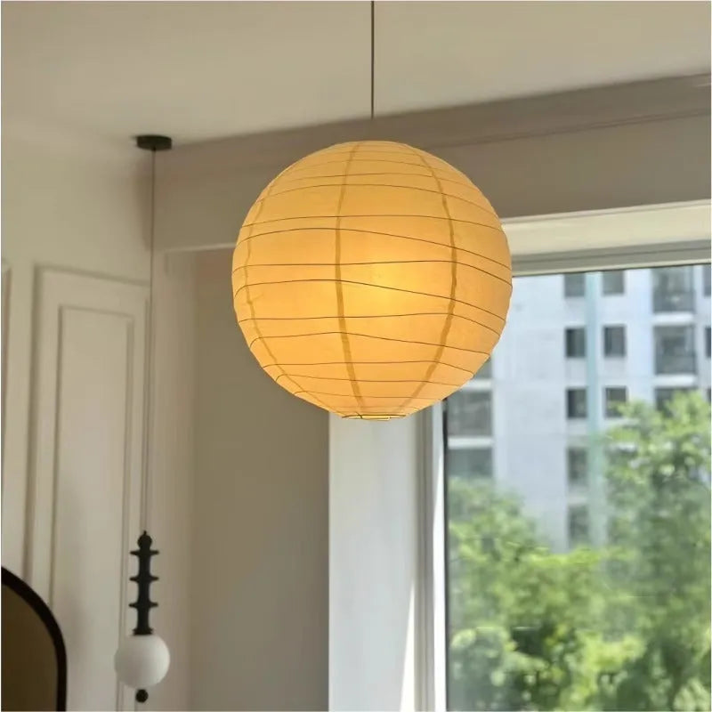 Japanese style rice paper ceiling chandelier lamp with a natural shade in a living room setting.