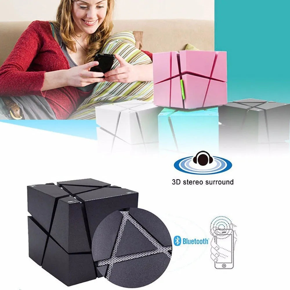 Cube Bluetooth Speaker with colourful lights in black ABS casing, front view on desk