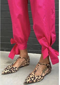 Leopard print women's pumps with pointed toe and low chunky heel featuring cross shoulder straps
