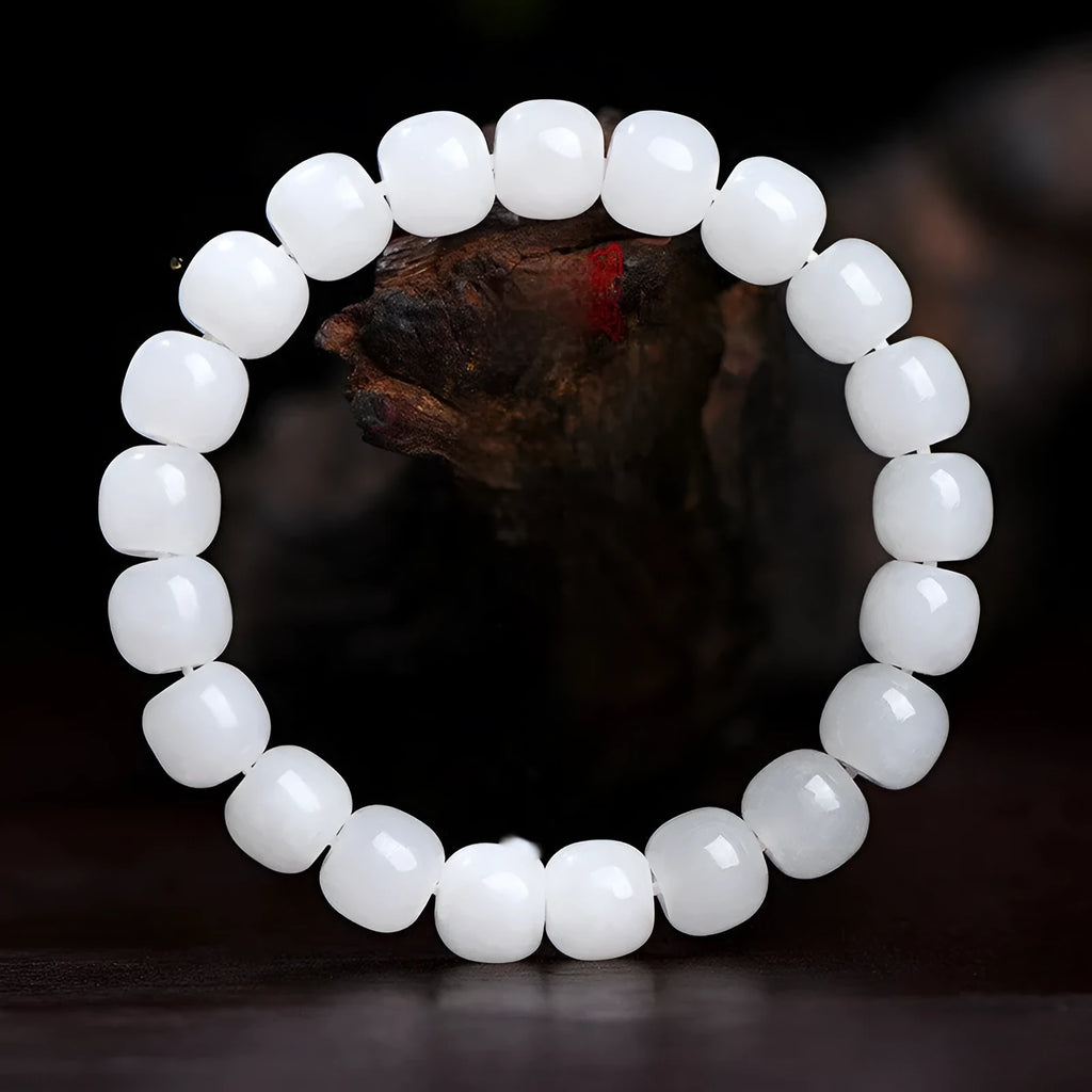 White Hetian jade barrel bead bracelet laid flat, showing unisex casual design.