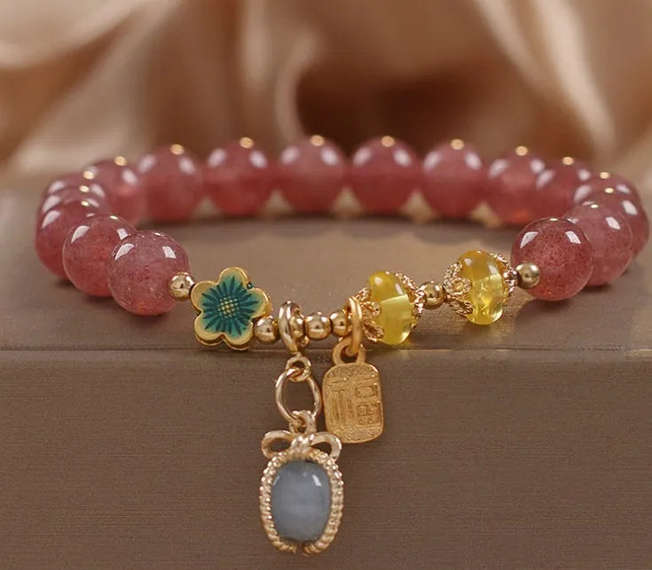 Red strawberry quartz beaded bracelet with alloy metal and rhinestone details
