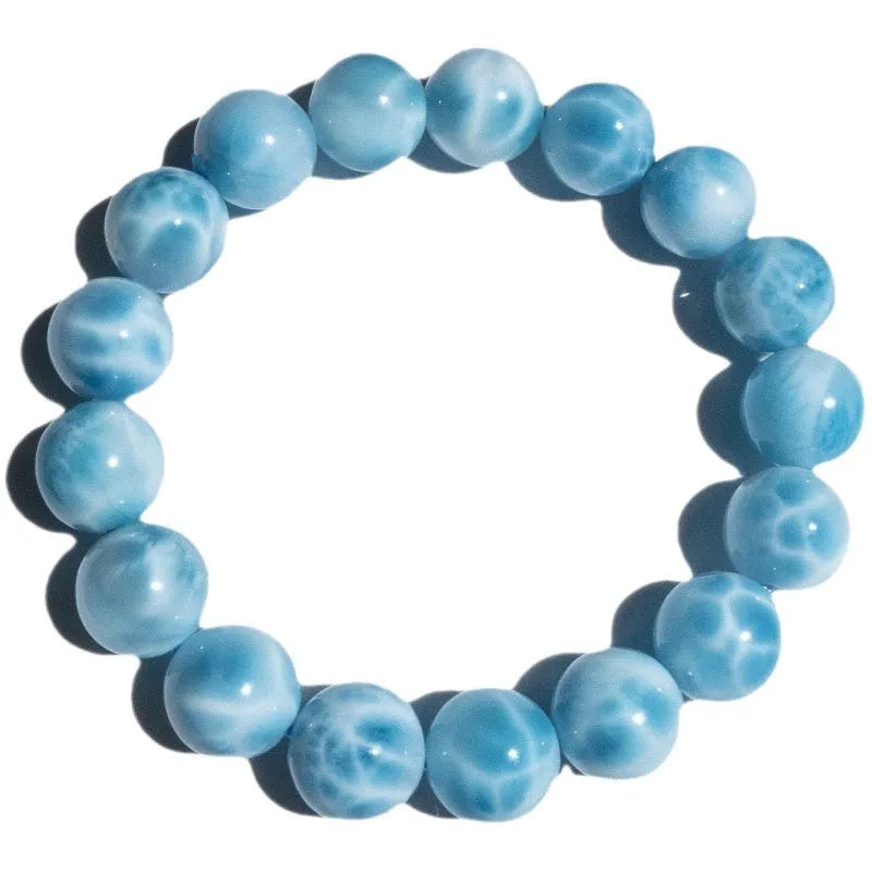 Blue and natural toned handmade bodhi bracelet with sea-pattern stones and pearl elements