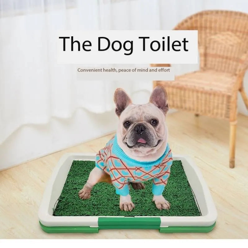 Green synthetic grass dog toilet training tray with plastic base and absorbent pad layer.