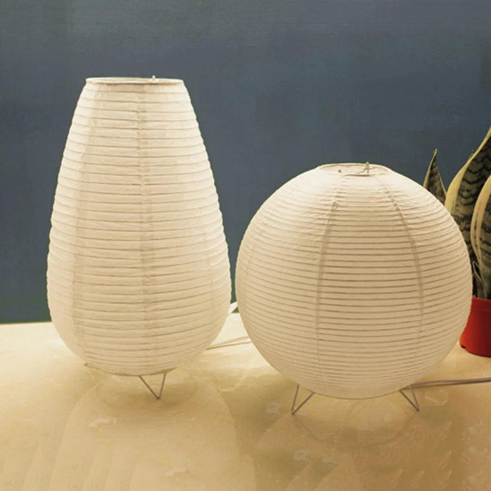 Small white table lamp with rice paper shade on bedside table, circular shape, traditional handwork