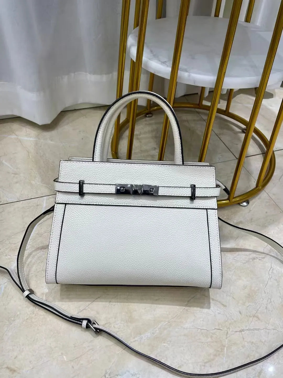 Small square genuine leather shoulder bag in horizontal design with organised interior compartments