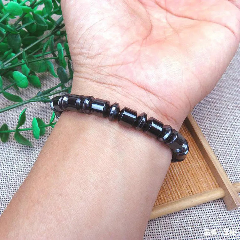 Black pentagram stone magnetic therapy bracelet with magnetite and hematite beads on a stretch band.