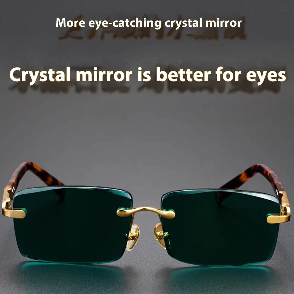A pair of frameless sunglasses with dark green crystal lenses, shown with a glasses case and cleaning cloth.