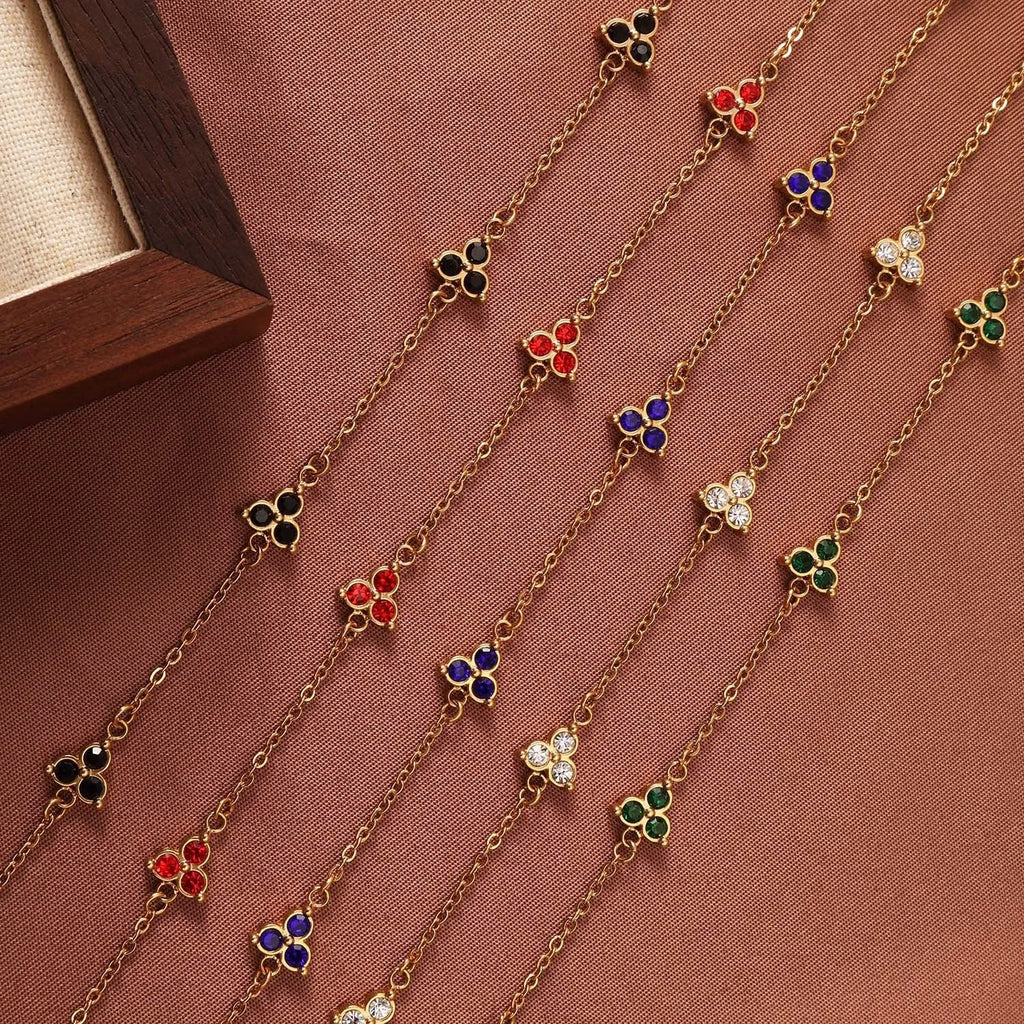 Women's stainless steel geometric bracelet with triangle elements and coloured stone settings