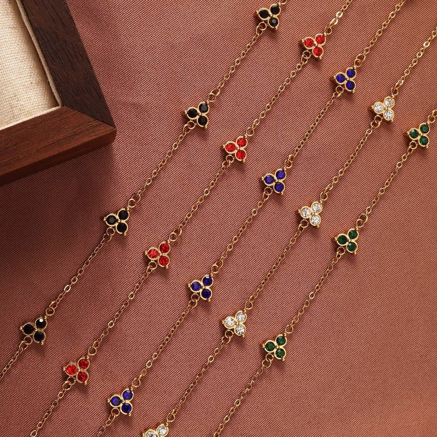 Women's stainless steel geometric bracelet with triangle elements and coloured stone settings