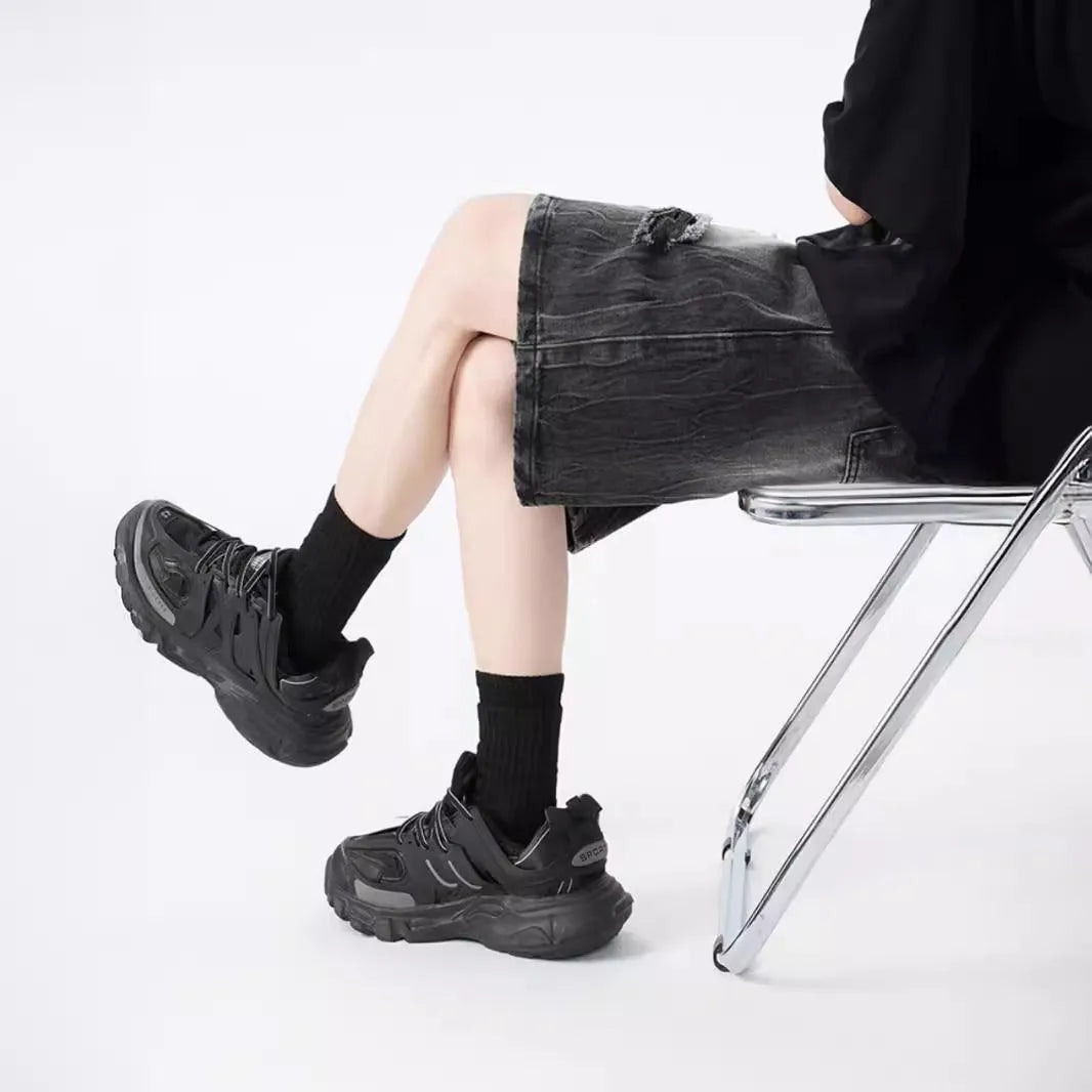 Washed denim shorts with ripped detailing in loose retro style, available in black or blue