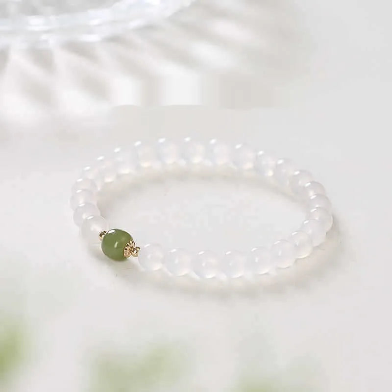 Handmade natural white agate crystal bracelet with cinnabar detail in 6mm or 8mm bead size.
