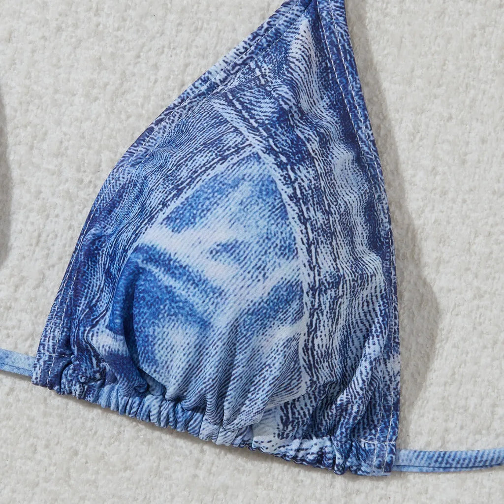 Denim blue printed women's bikini set with strap design on a model, showing front and back.