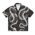 Short sleeve loose-fit shirt with a Cuban collar and a printed snake bone floral pattern.
