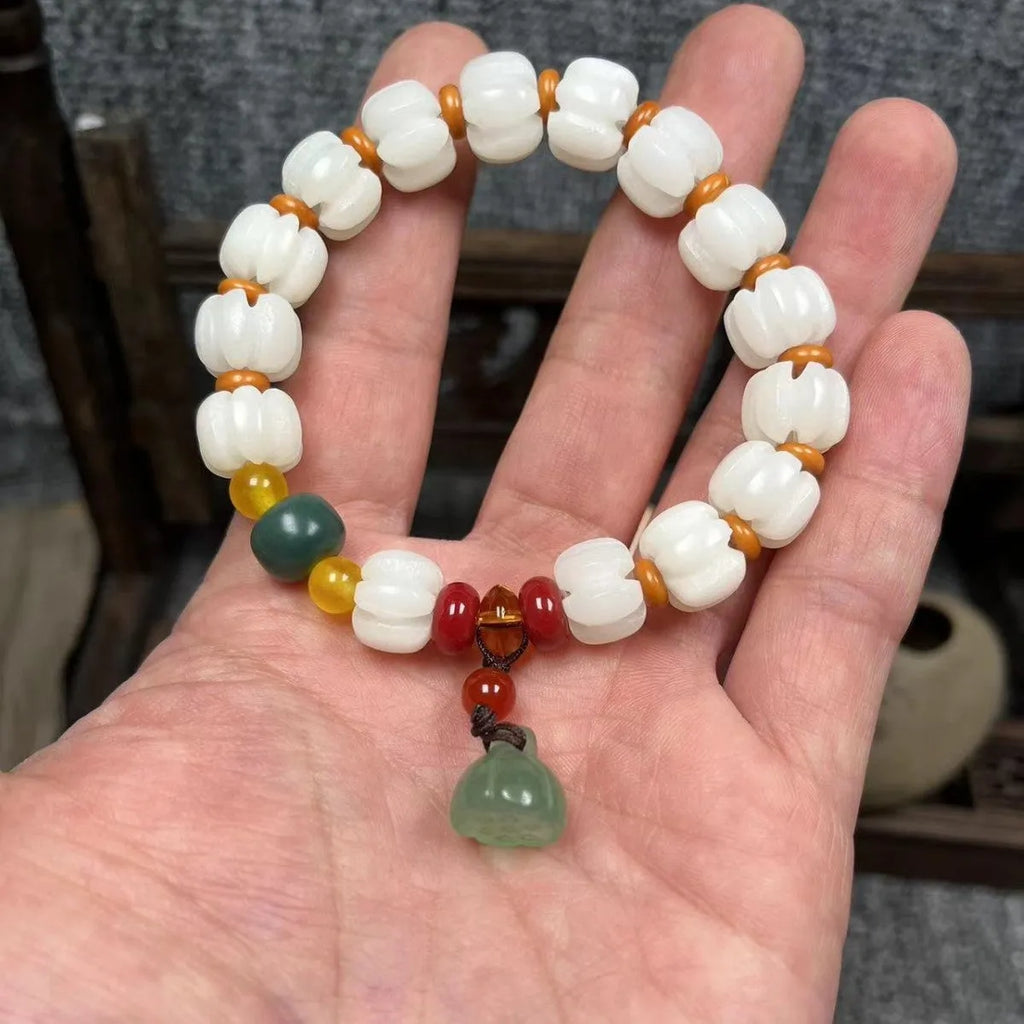 Carved pumpkin and lotus bead bracelet made from Bodhi root with white jade and aventurine details.