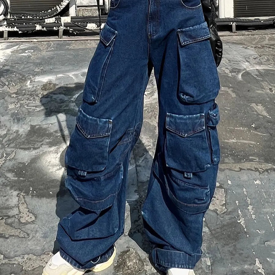 Dark blue distressed wide-leg high-waist jeans with multiple pockets on a denim background.