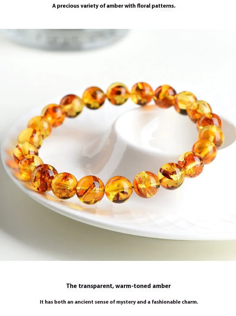 Natural yellow piebald amber bracelet with geometric beads on wrist