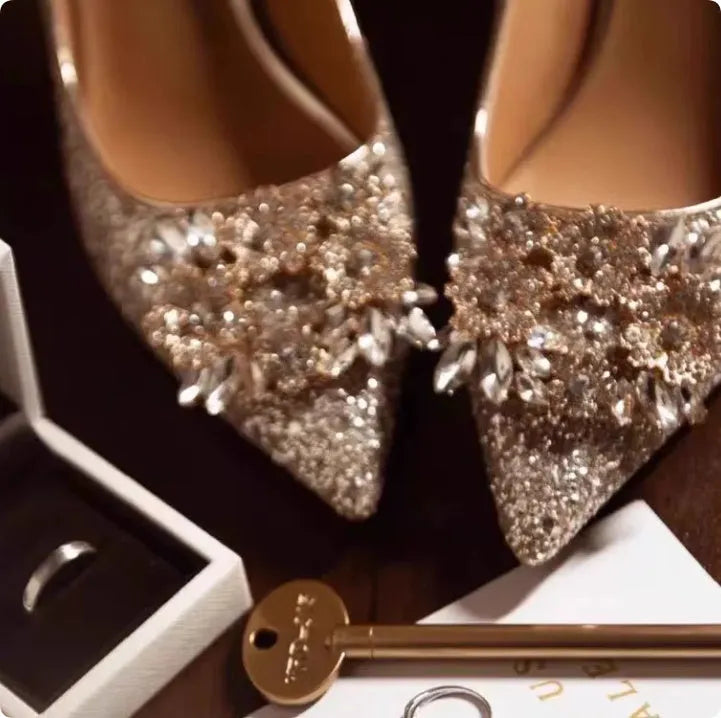 Champagne coloured pointed toe bridal heels with rhinestone patterns on a fine heel.