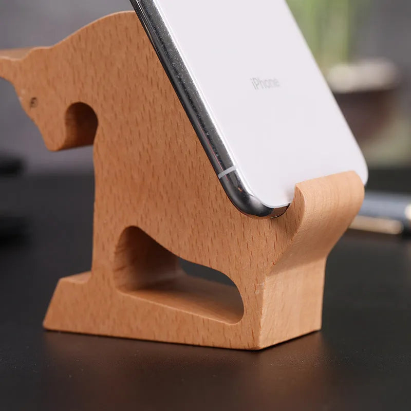 Beech wood mobile phone holder stand with coin slot and decorative carving.
