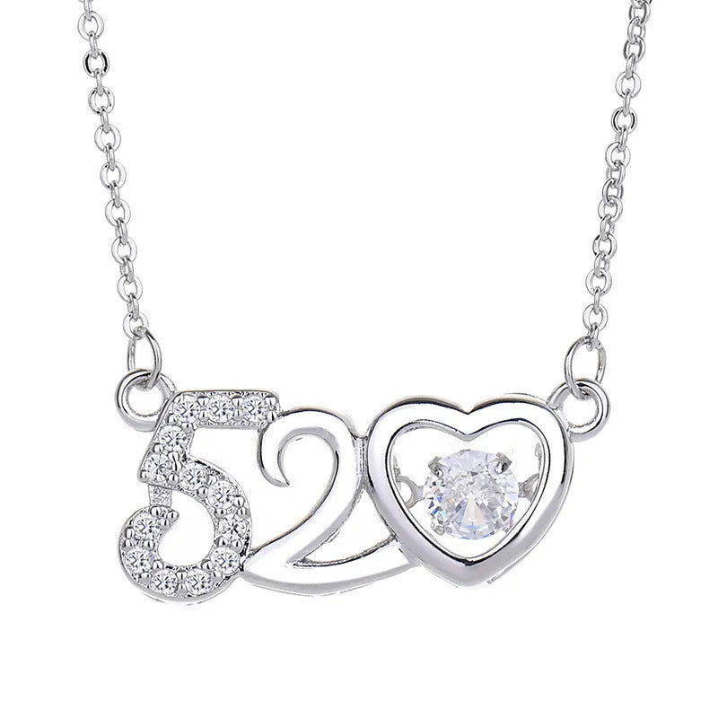 Women's silver heart-shaped pendant necklace with crown and bow decoration on a delicate chain.