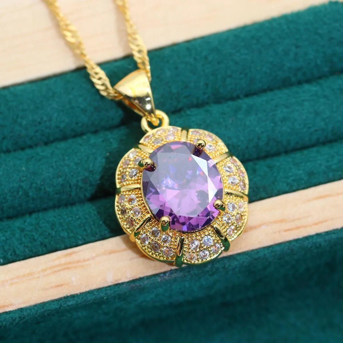 Gold plated jewellery set with colourful cubic zirconia stones, showing ring, earrings, bracelet, and necklace.