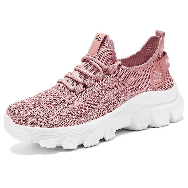 Women's white Flyknit running sneaker with thick PVC sole and lace-up front on a neutral background.