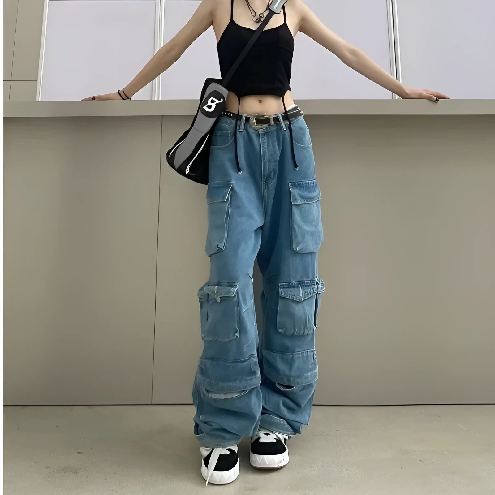 Women's blue tie-dyed high waist wide leg jeans with multiple pockets on a street style background.