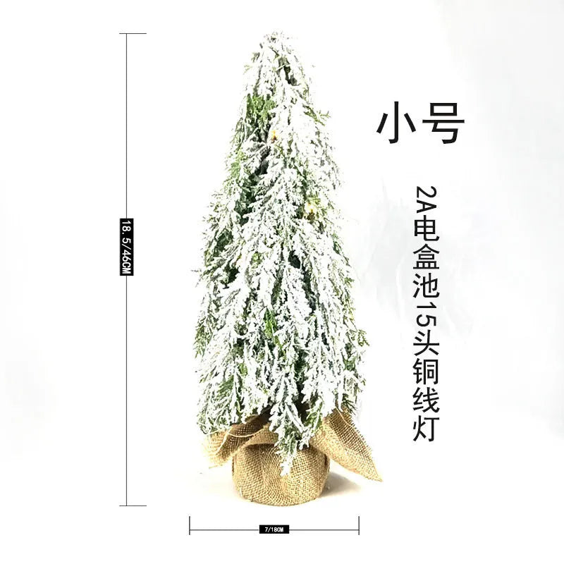 Small 24-inch artificial Christmas tree with battery-powered lights and PE simulated snow spray on branches