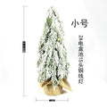 Small 24-inch artificial Christmas tree with battery-powered lights and PE simulated snow spray on branches