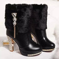 Women's black ankle boot with a high chunky heel on a white background.