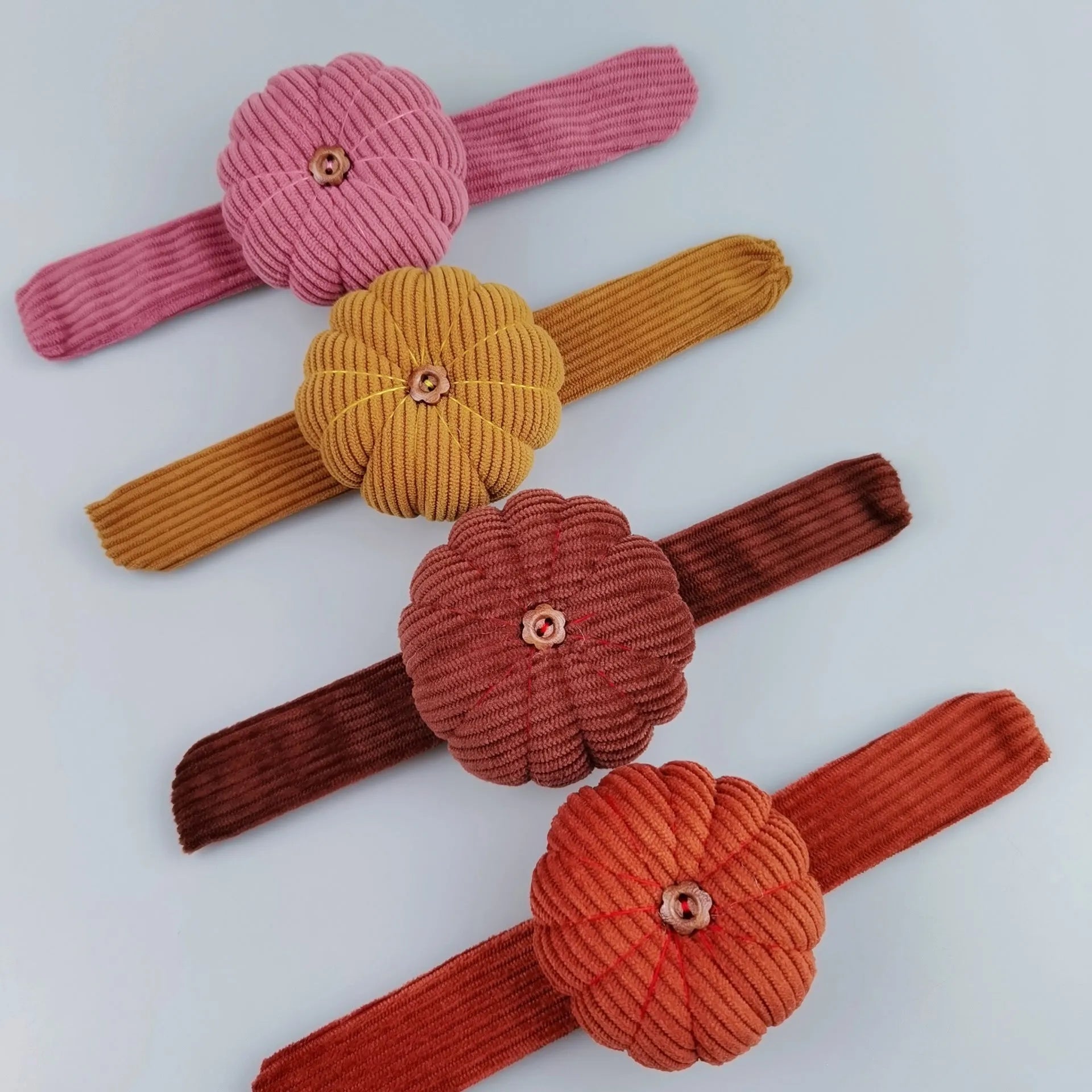 Ring pincushion sewing tool with vertical cutting slot in caramel colour showing fabric cushion and metal ring base