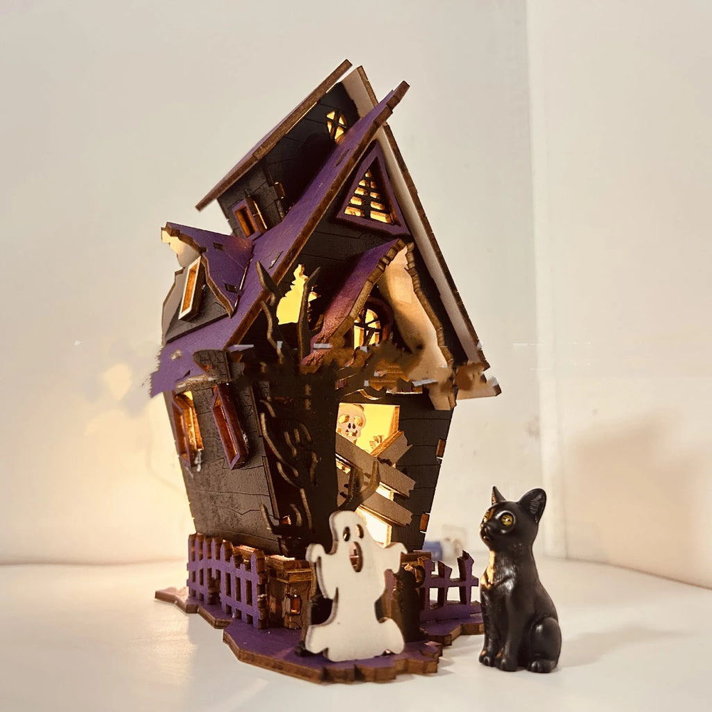 Wooden glowing haunted house Halloween table decoration on a dark surface